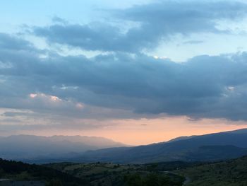 Scenic view of mountains against sky at sunset