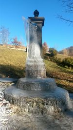 Close-up of water fountain against blue sky