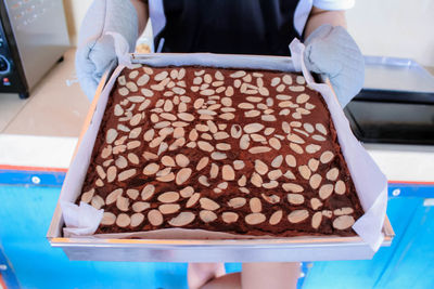 Midsection of man standing in tray