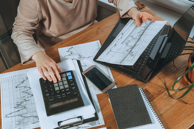 Midsection of man working on table