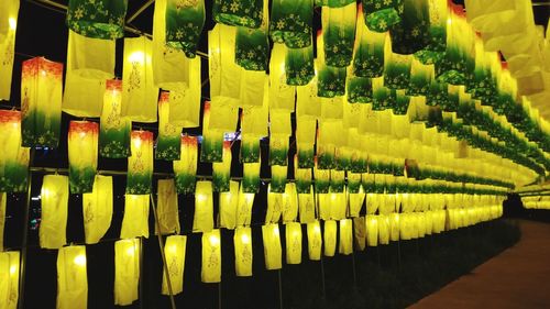 Low angle view of illuminated lanterns hanging at night