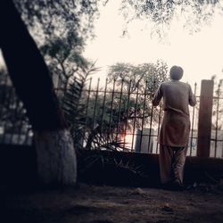 Full length of woman standing against sky