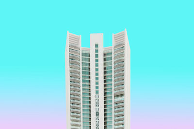 Low angle view of modern buildings against blue sky