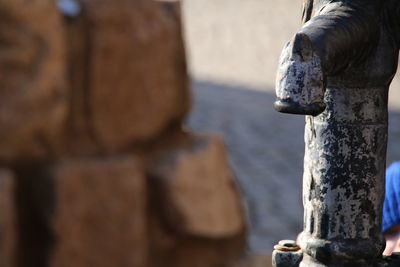 Close-up of hand statue by water