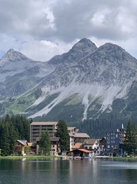 Scenic view of lake by mountains against sky