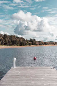 Pier over lake against sky