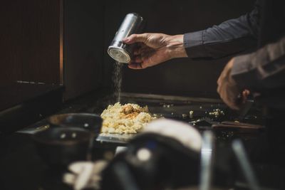 Midsection of man preparing food