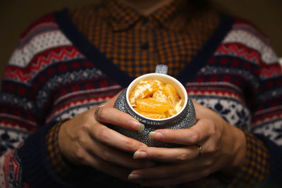Midsection of woman holding ice cream