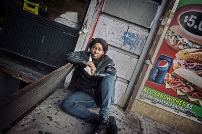 Portrait of a smiling man sitting in city