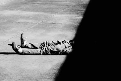 Low section of man lying on footpath