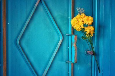 Close-up of blue flower on wooden door