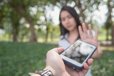 Midsection of woman using mobile phone outdoors