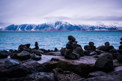 Stack of rocks on beach against sky