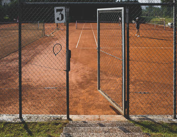 Open gate at tennis clay court