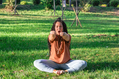 Woman is doing yoga asana outside in a park. concept of balancing and healthy lifestyle.