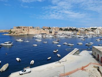 High angle view of buildings by sea against sky