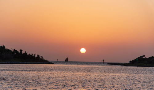 Scenic view of sea against romantic sky at sunset