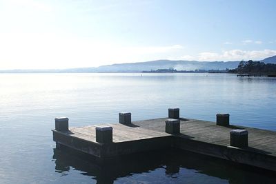 Pier on lake against sky