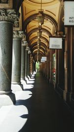 Empty corridor along pillars