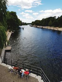 High angle view of people by river against sky