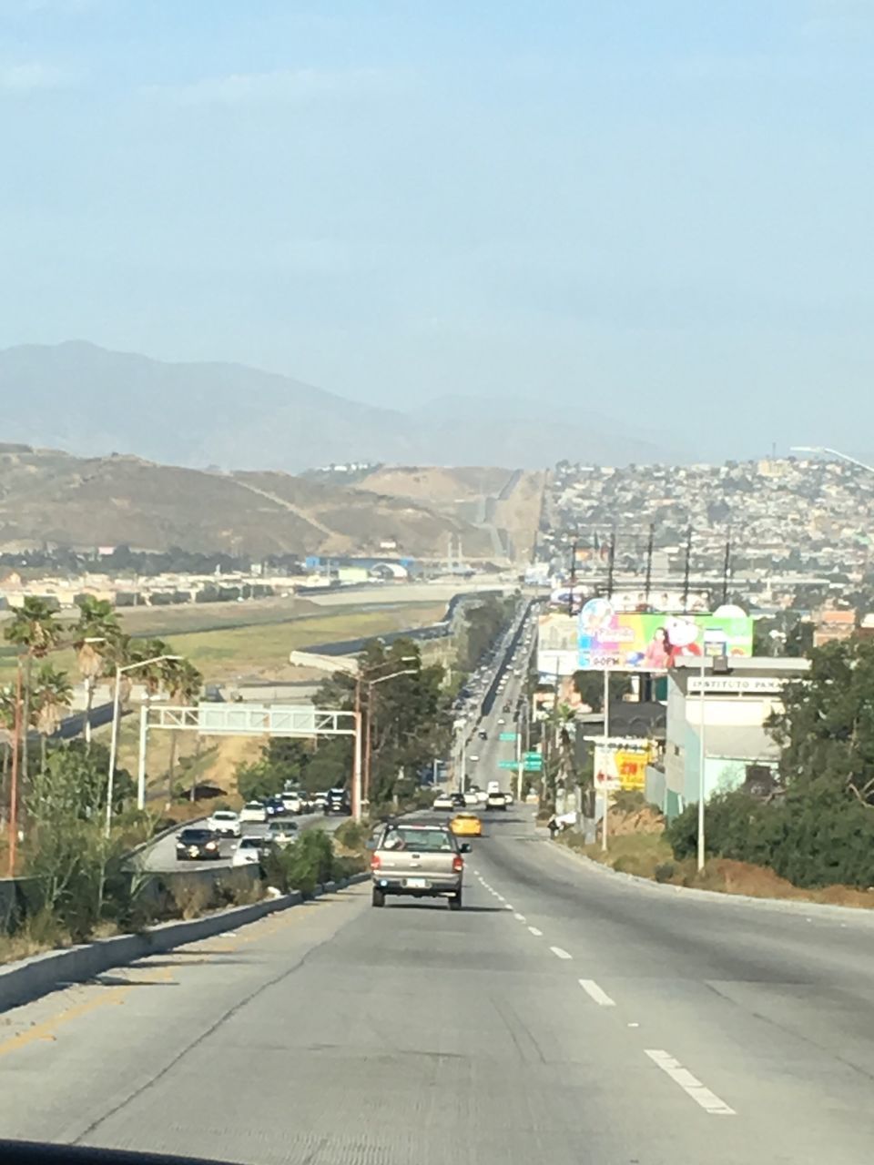 CARS ON STREET AGAINST SKY IN CITY