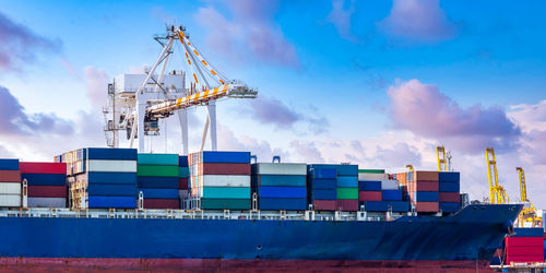 Commercial dock against cloudy sky