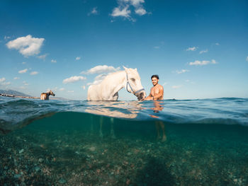 Rear view of man swimming in sea