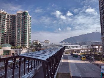 Bridge by swimming pool against buildings in city