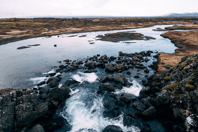 Aerial view of rocks in sea during winter