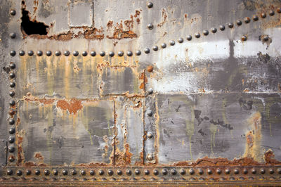 Metal industrial background with rivets and rust