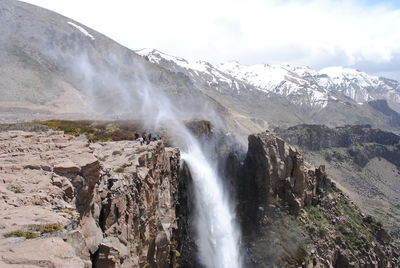 Scenic view of waterfall against sky