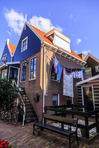 Houses and buildings in town against sky