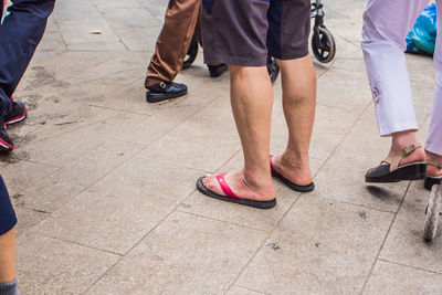 Low section of people walking on footpath