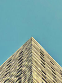 Low angle view of modern building against clear blue sky