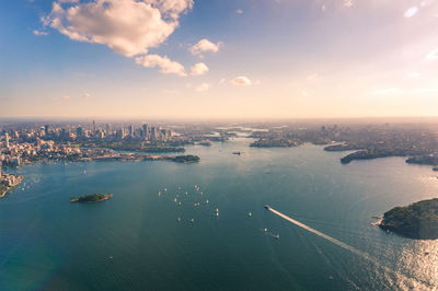 High angle view of buildings by sea against sky