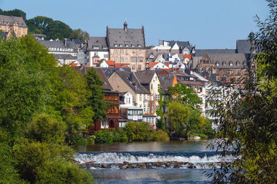 Buildings in city against clear sky