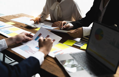 Midsection of business colleagues working at office