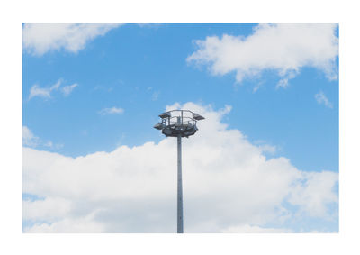 Low angle view of windmill against blue sky