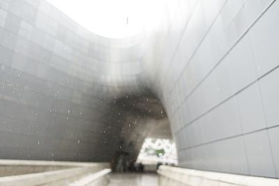 Person walking seen through wet glass