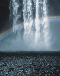 Idyllic view of rainbow against skogafoss waterfall