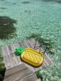 High angle view of yellow pier by sea