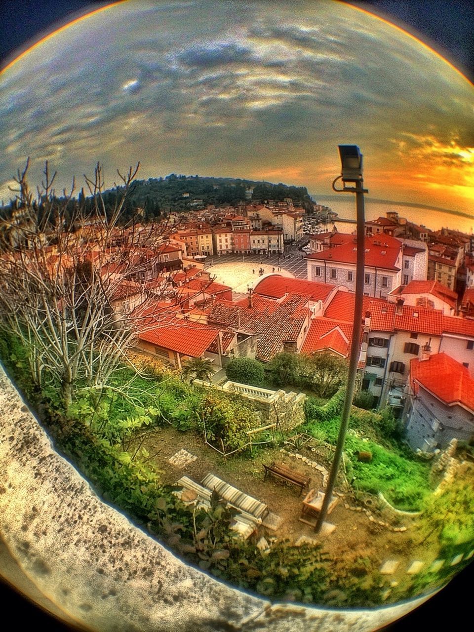 architecture, building exterior, built structure, sky, tree, city, high angle view, sunset, cityscape, cloud - sky, fish-eye lens, residential district, residential building, residential structure, outdoors, house, no people, orange color, nature, crowded