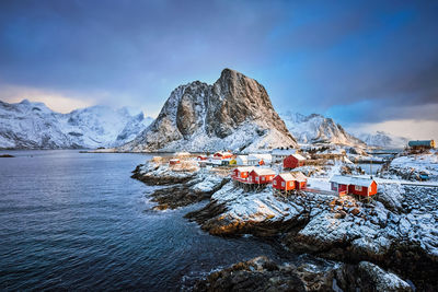 Scenic view of sea and mountains against sky