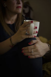 Midsection of woman using mobile phone