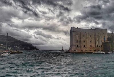 Scenic view of sea against storm clouds