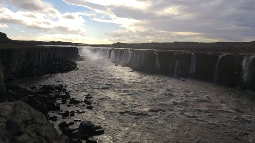 Scenic view of waterfall at beach