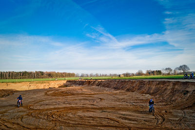 People biking on dirt field