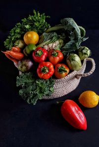 Fresh vegetables and fruits against black background