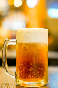 Close-up of beer glass on table