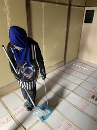 High angle view of man working on floor at home